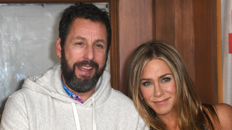 Jennifer Aniston posing with Adam Sandler