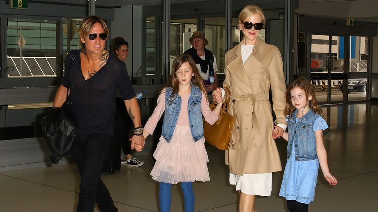 Keith Urban and Nicole Kidman walking with their daughters