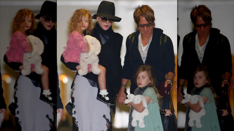 Keith Urban and Nicole Kidman walking with their daughters