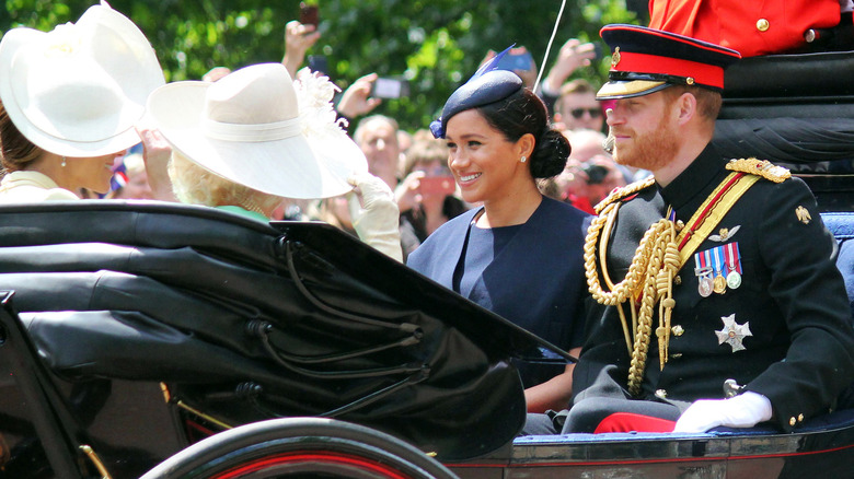 Meghan Markle and Prince Harry riding in a carriage for Trooping the Colour with Camilla and Kate Middleton