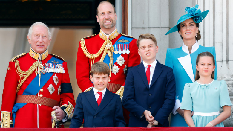 King Charles, William, Prince of Wales, Catherine, Princess of Wales, Prince Louis, Princess Charlotte, and Prince George standing on the Buckingham Palace balcony