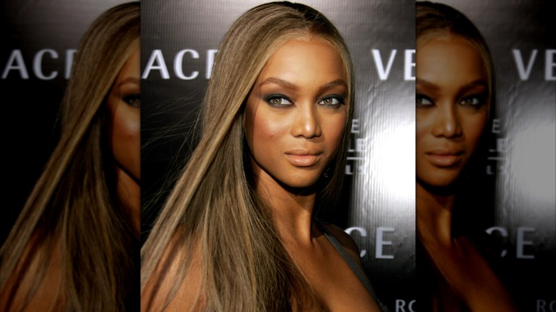 Tyra Banks posing on the red carpet circa 2007 at a Versace event