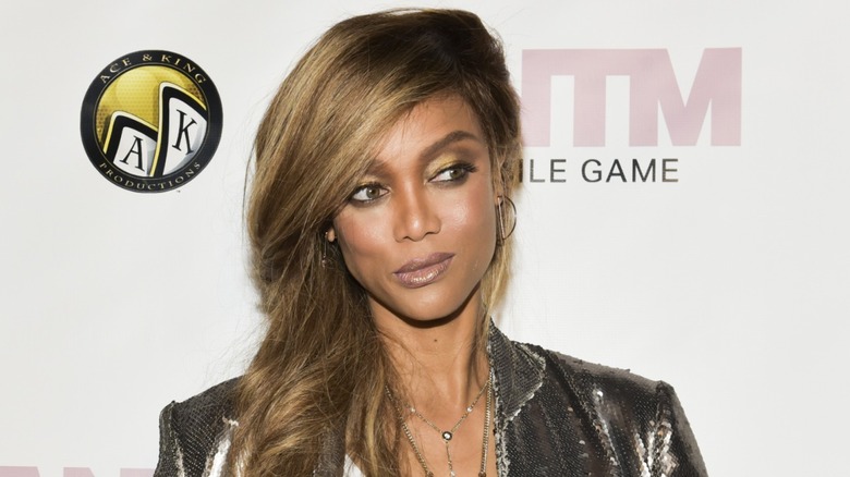 Tyra Banks posing on the red carpet for the "ANTM" Mobile Game