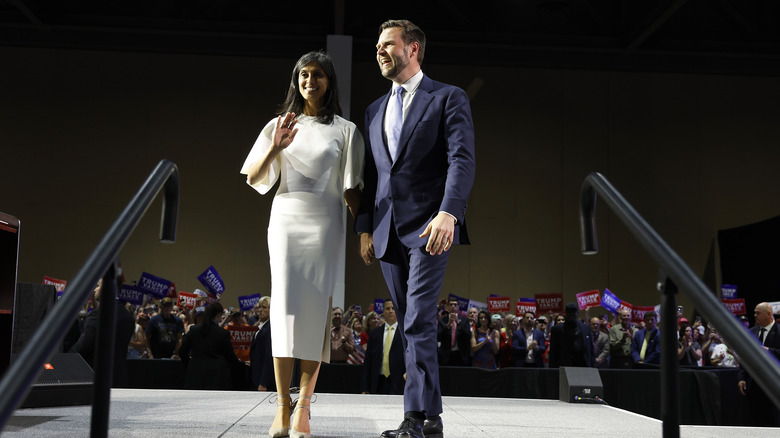 Usha Vance waving at a crowd next to JD Vance.