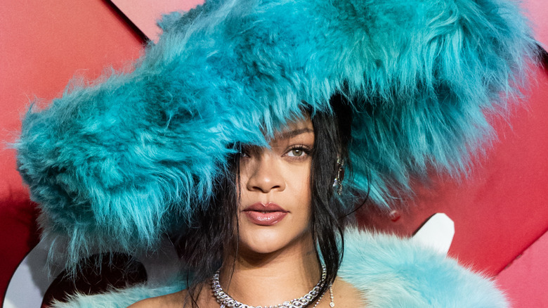 Rihanna wearing a blue fuzzy hat
