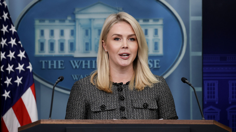 Karoline Leavitt giving a press briefing in a glittery blazer