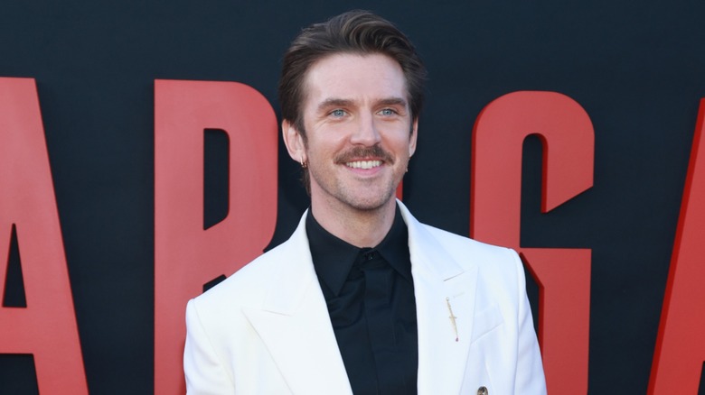Dan Stevens smiling on the red carpet while attending a movie premiere