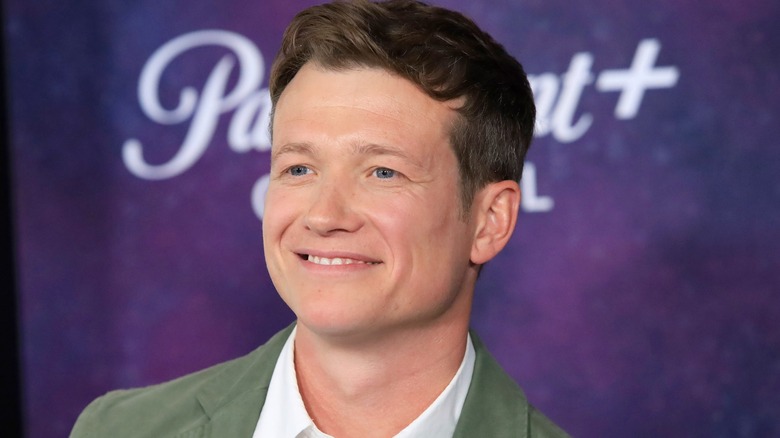 Ed Speleers smiling at a Paramount+ event
