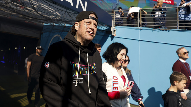 Jelly Roll attends an NFL game with a clean-shaven face