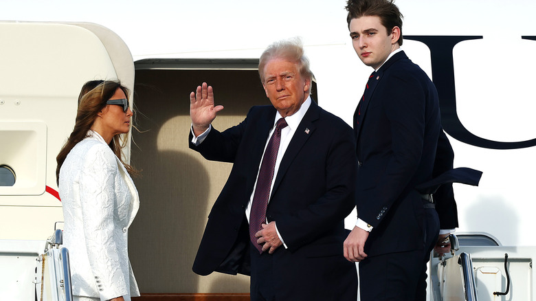 Barron Trump boarding an airplane with Donald and Melania Trump