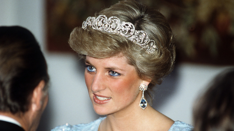 Princess Diana at a state banquet wearing a diamond tiara and sapphire diamond earrings