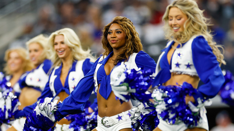 Dallas Cowboys cheerleaders performing in uniform 