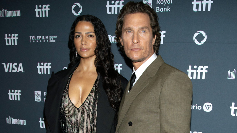 Camila Alves McConaughey wearing a black dress and Matthew McConaughey wearing a gray suit
