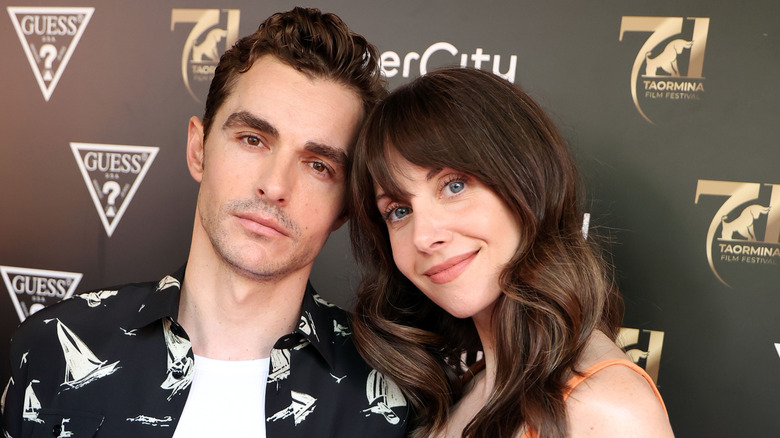 Dave Franco and Alison Brie tilting their heads together at the 71st Taormina Film Festival