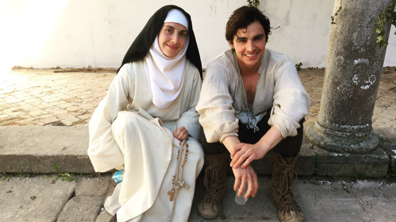 Alison Brie wearing a nun costume and sitting next to Dave Franco