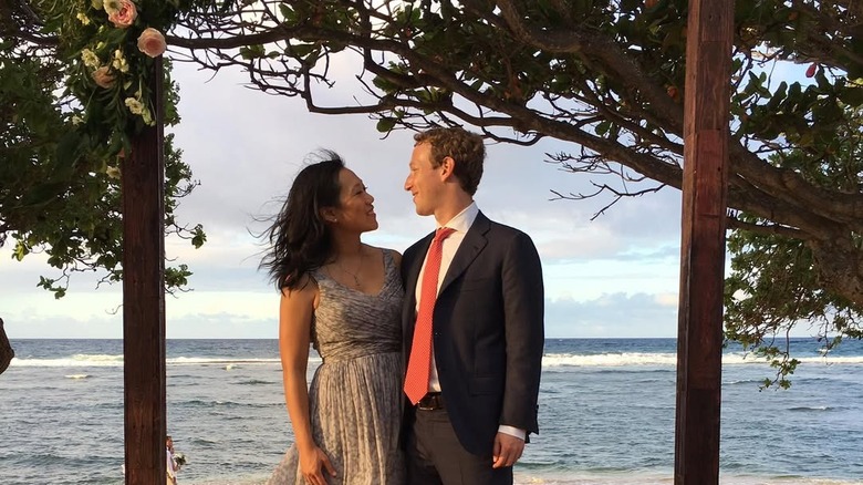 Mark Zuckerberg and Priscilla Chan looking at each other at a wedding