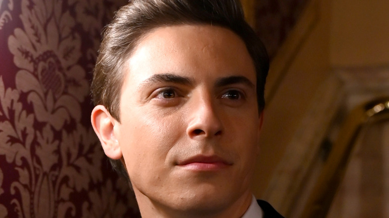 Derek Klena posing inside Broadway theater