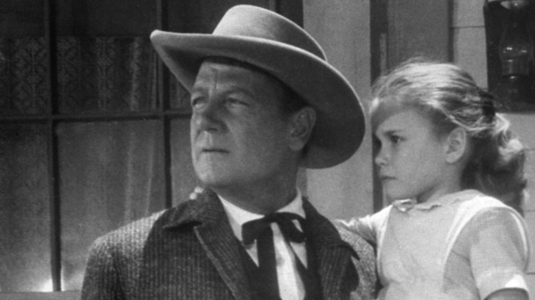 Joel McCrea (1905 - 1990) and an unidentified child actor on the set of unspecified movie, Hollywood, California, 1945.