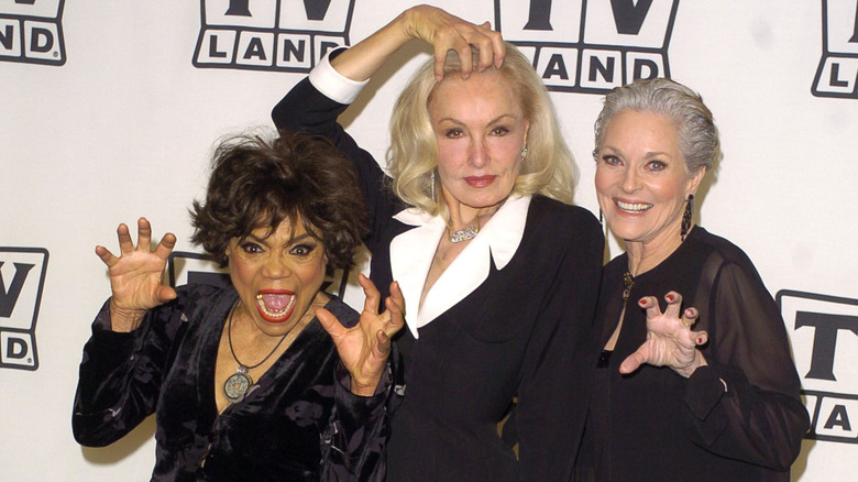 Eartha Kitt, Julie Newmar, and Lee Meriwether posing together in 2004