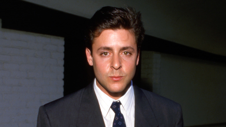 Judd Nelson with short hair posing.