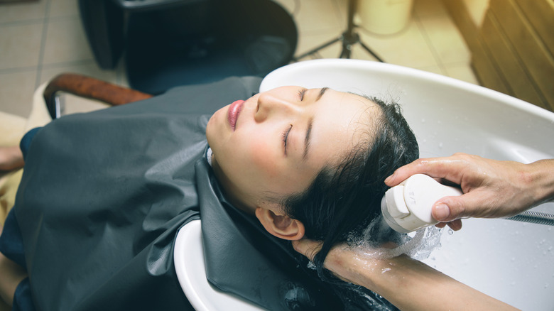 Woman at shampoo station