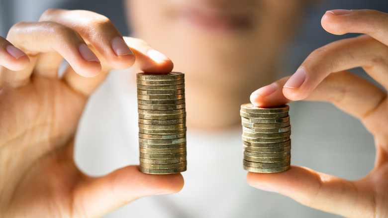 Woman holding up coins to signify the wage gap