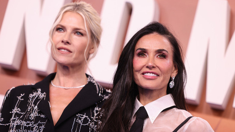 Ali Larter and Demi Moore posing together at a Landman event