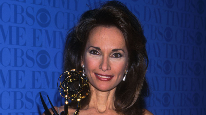 Susan Lucci smiling with an Emmy Award visible
