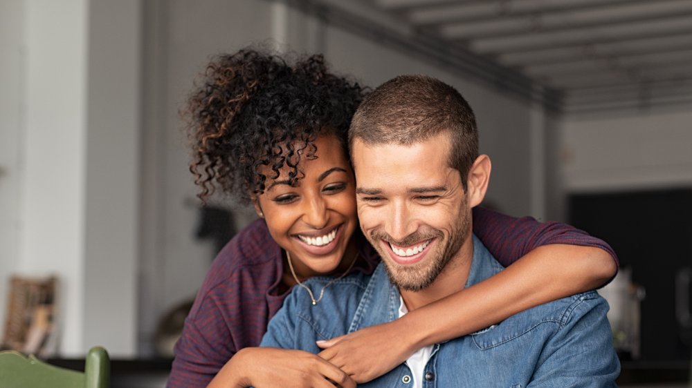 man and woman hugging