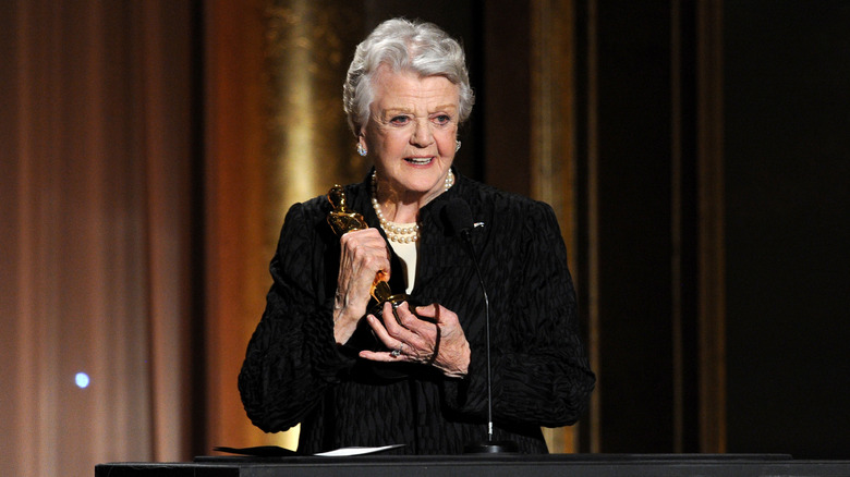 Angela Lansbury holding her honorary Oscar