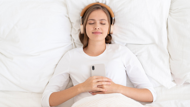 Woman meditating in bed