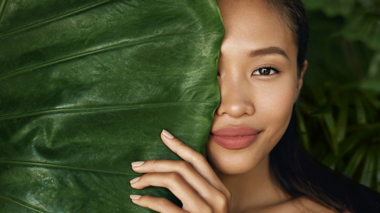 Woman behind a leaf