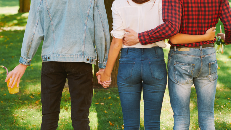 three people holding hands