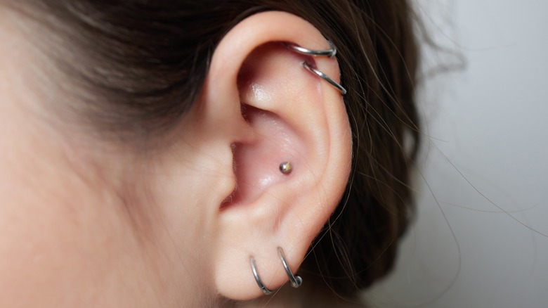 Woman with cartilage piercings