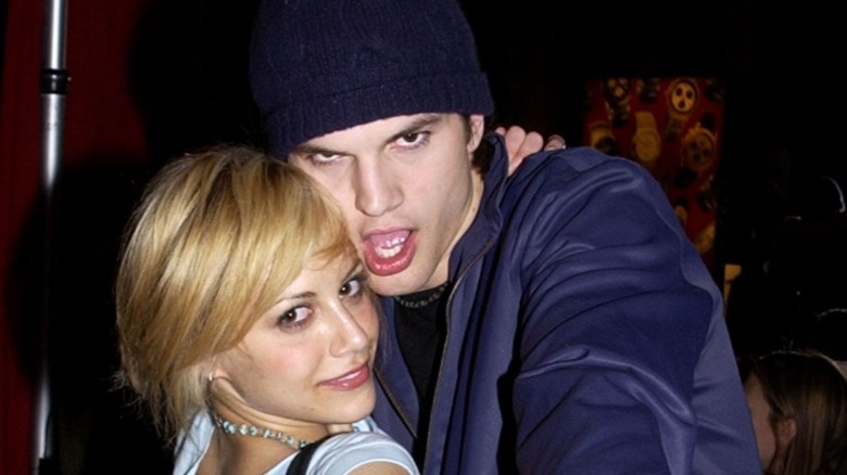 Brittany Murphy and Ashton Kutcher embracing and posing for camera
