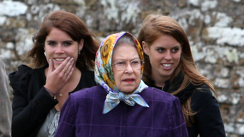 Princess Eugenie, Princess Beatrice, and Queen Elizabeth II on an outdoor walk