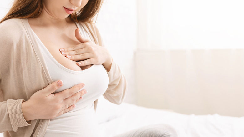Woman checking her breasts 