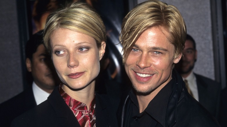 Brad Pitt and Gwyneth Paltrow posing together with similar hairstyles.