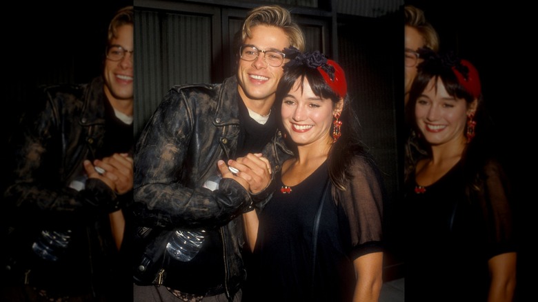 Jill Schoelen and Brad Pitt posing together smiling in black outfits.