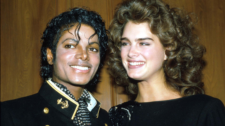 A young Michael Jackson and Brooke Shields smile and pose for a photo