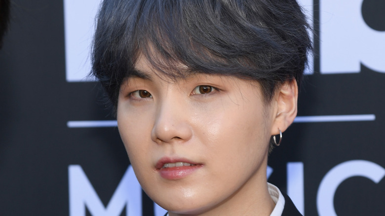 Suga of BTS attends an event