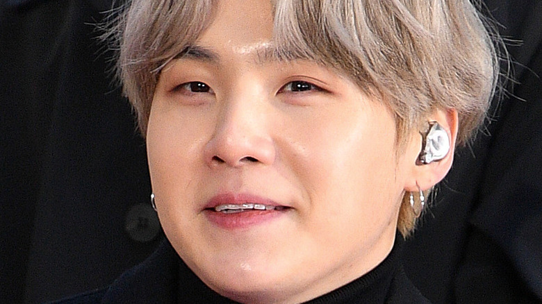 Suga of BTS smiles during an interview