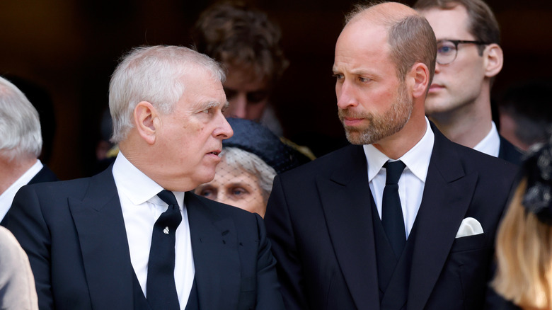 Prince Andrew speaking to Prince William