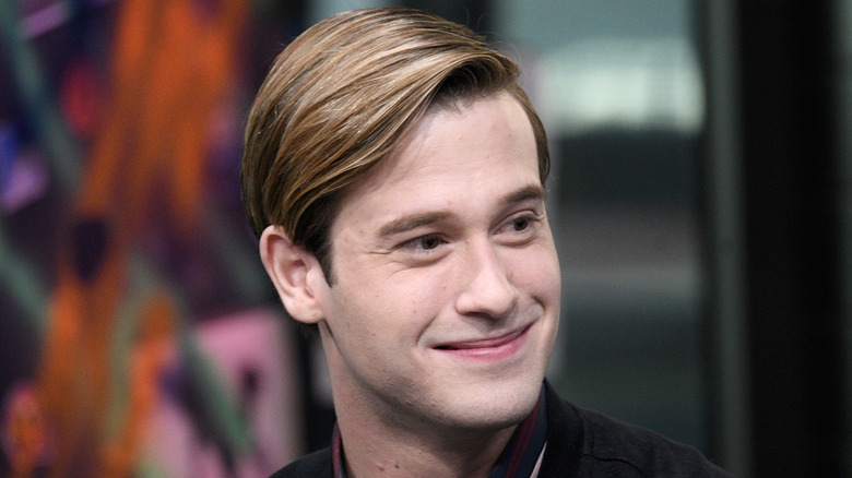 Tyler Henry smiling in an interview
