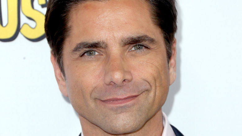 John Stamos smiling for photo 