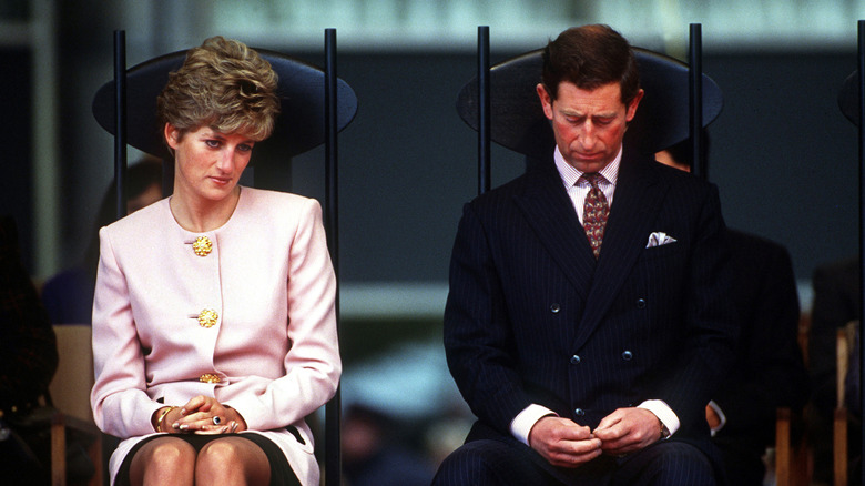 Princess Diana and Prince Charles sit at an event