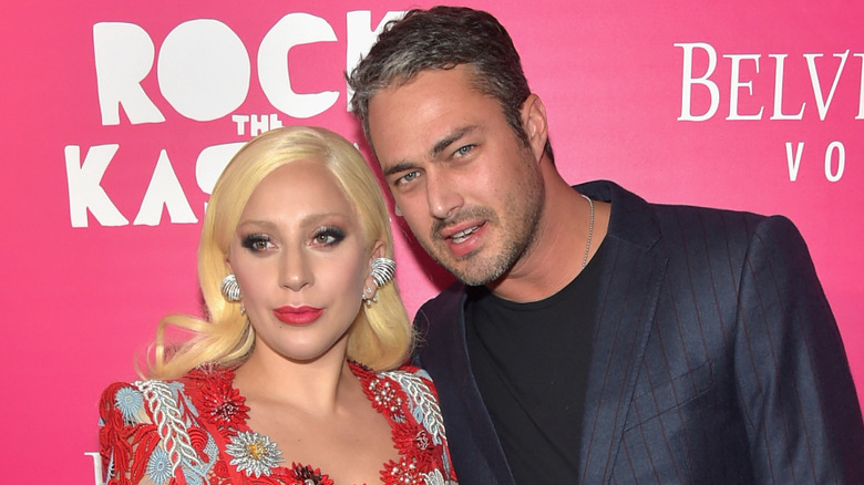 Lady Gaga posing at an event with Taylor Kinney