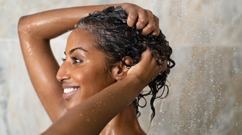 woman hair conditioner in shower 