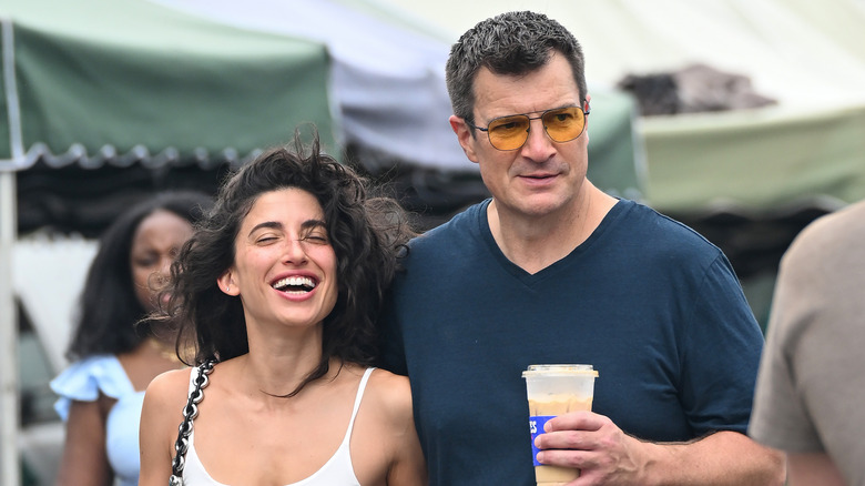 Nathan Fillion and Tania Raymonde are seen at the farmers market on September 21, 2025 in Studio City, California.