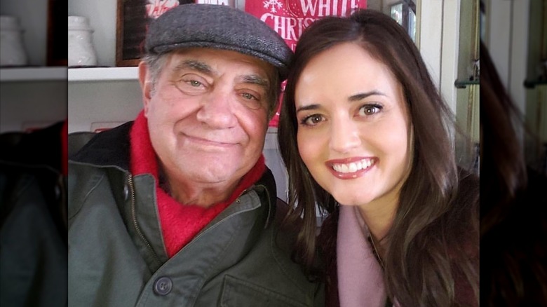 Dan Lauria and Danica McKellar leaning in together and smiling for a photo.